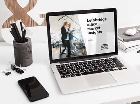 laptop computer on a desk displaying the Lethbridge office market report